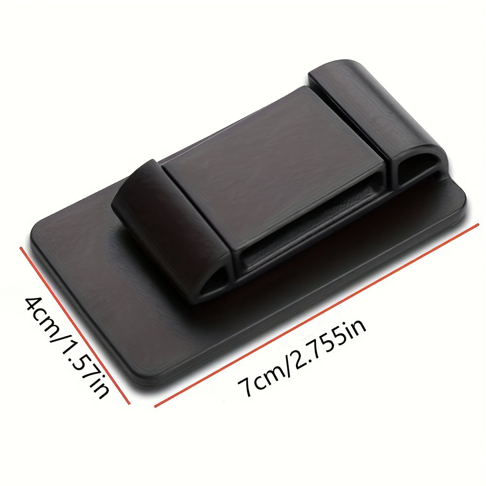 Black textured plastic seat belt stabilizer by Temu, showing its compact design and surface detail in a close-up view.