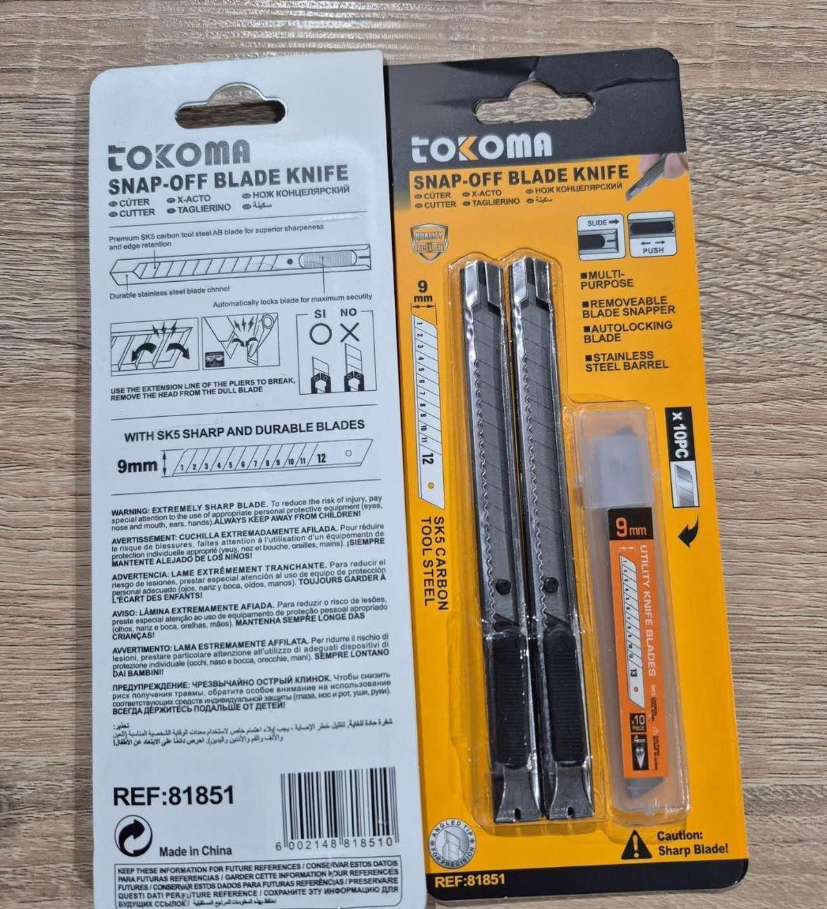 Tokoma Snap Off Blade Knife with SK5 carbon steel blade, featuring a black handle and snap-off segments for versatile cutting.