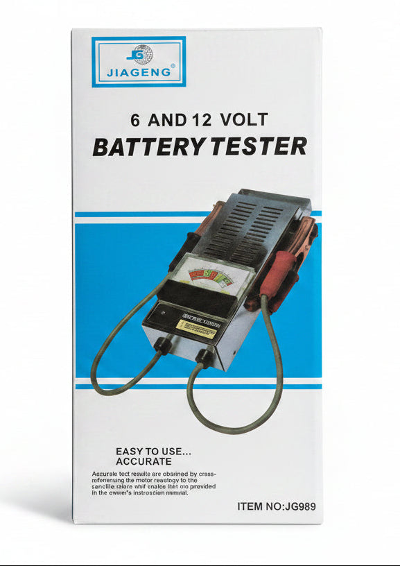 A boxed battery tester product on a dark wooden surface. The box is white with blue bands and a printed photo of the tester device.
