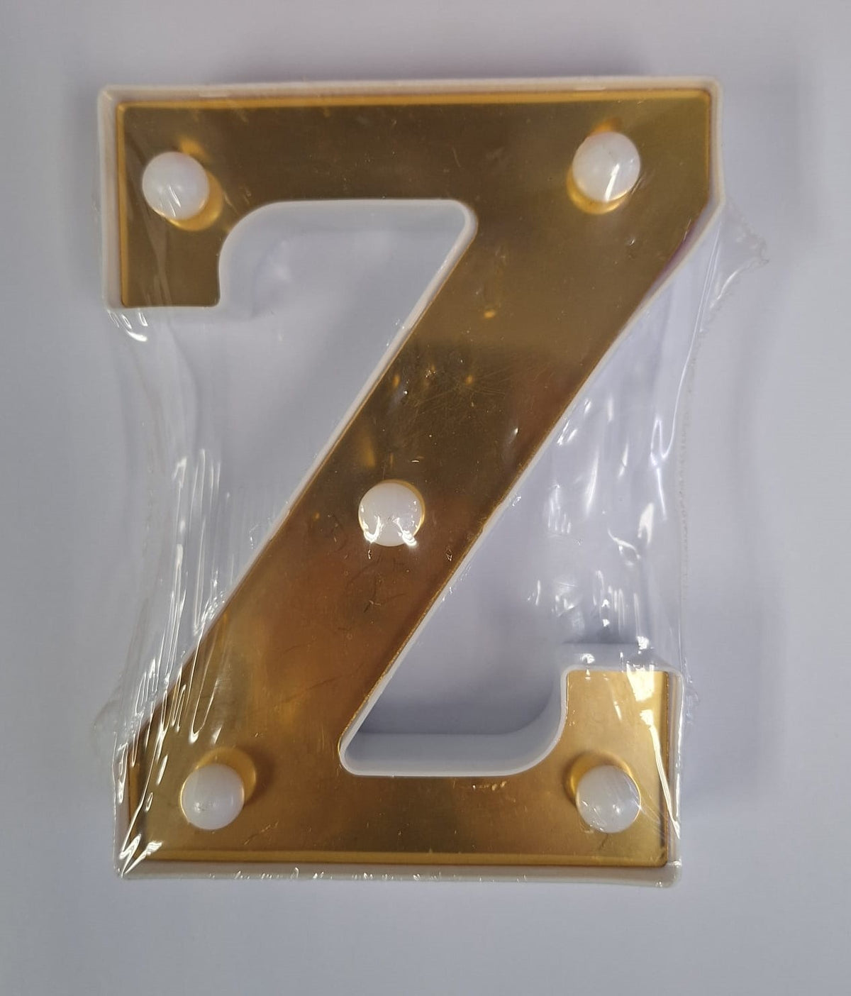 Gold and white decorative letters that light up, styled for home decor by ET, with illuminated letter design.