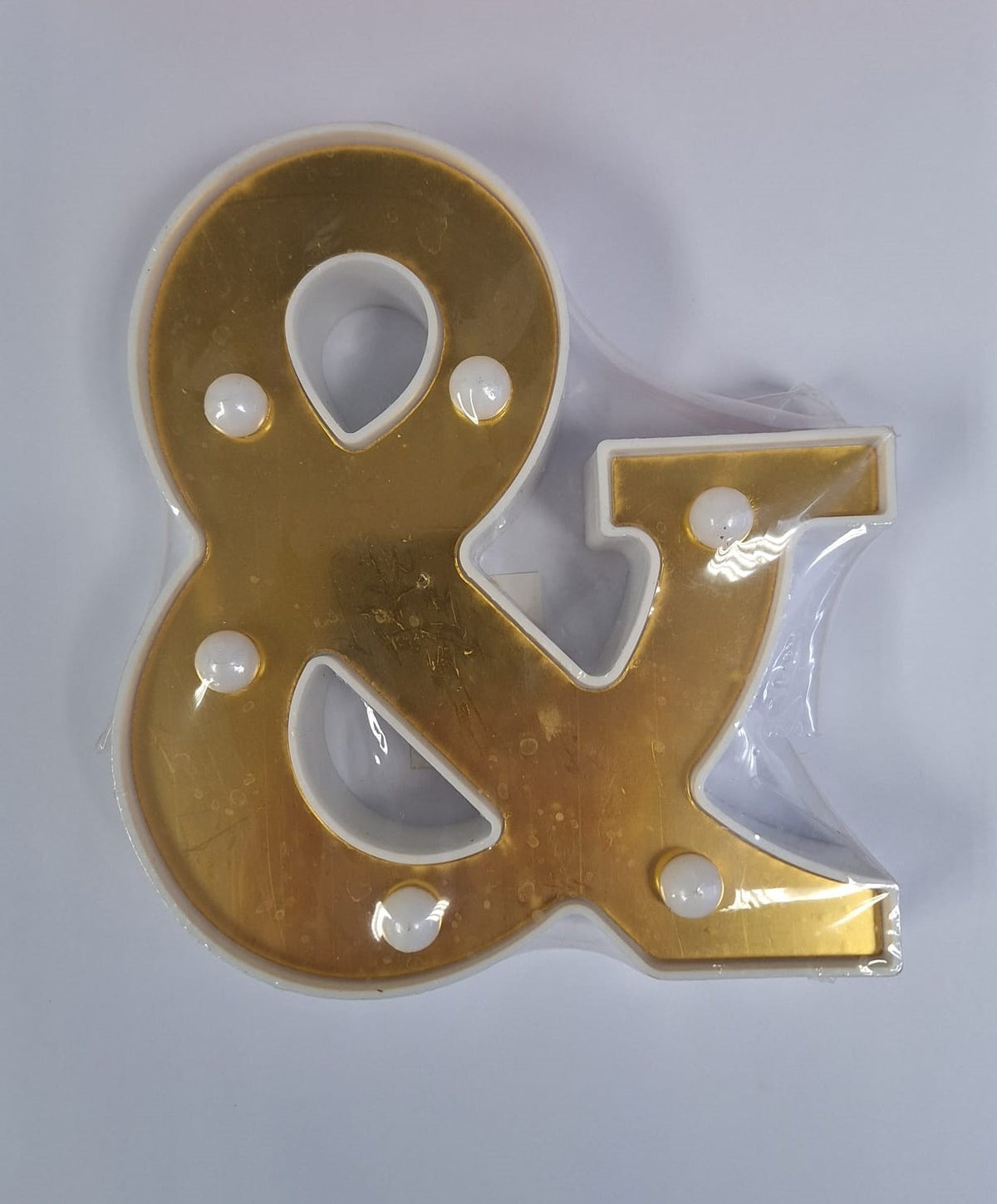 Gold and white decorative letters that light up, designed by ET, showcasing illuminated lettering for stylish home decor.