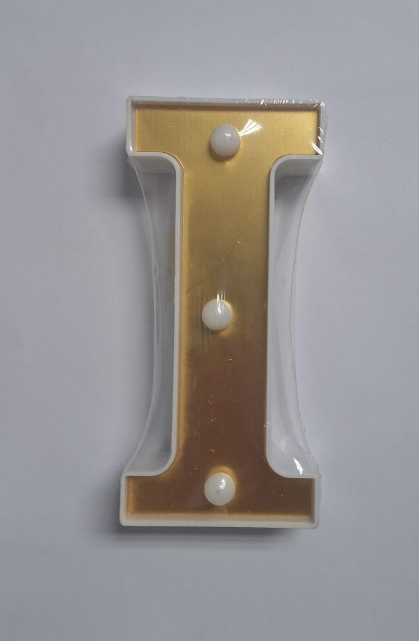 Gold and white decorative letters that light up, spelling out a word, from ET, illuminated for decorative display.