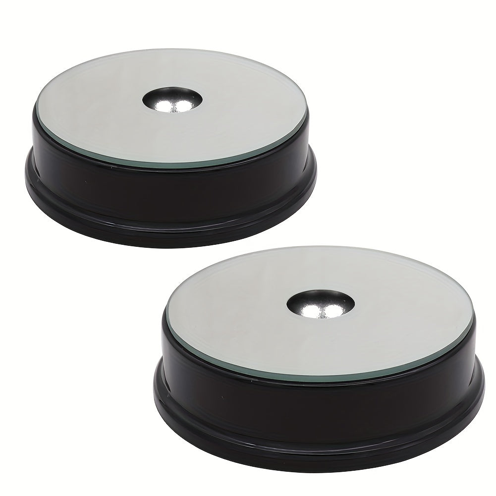 Two multicolor LED display stands with black bases and mirror tops, ideal for showcasing collectibles or decorative items.