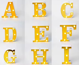Gold and white decorative letters that light up, branded ET, showcasing illuminated letter design for home decor.