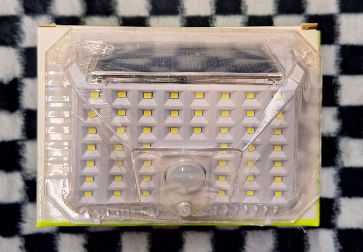 ET GDPLUS Solar Motion Lamp outdoor security light with motion sensor, black finish, mounted on wall, ready for outdoor use.