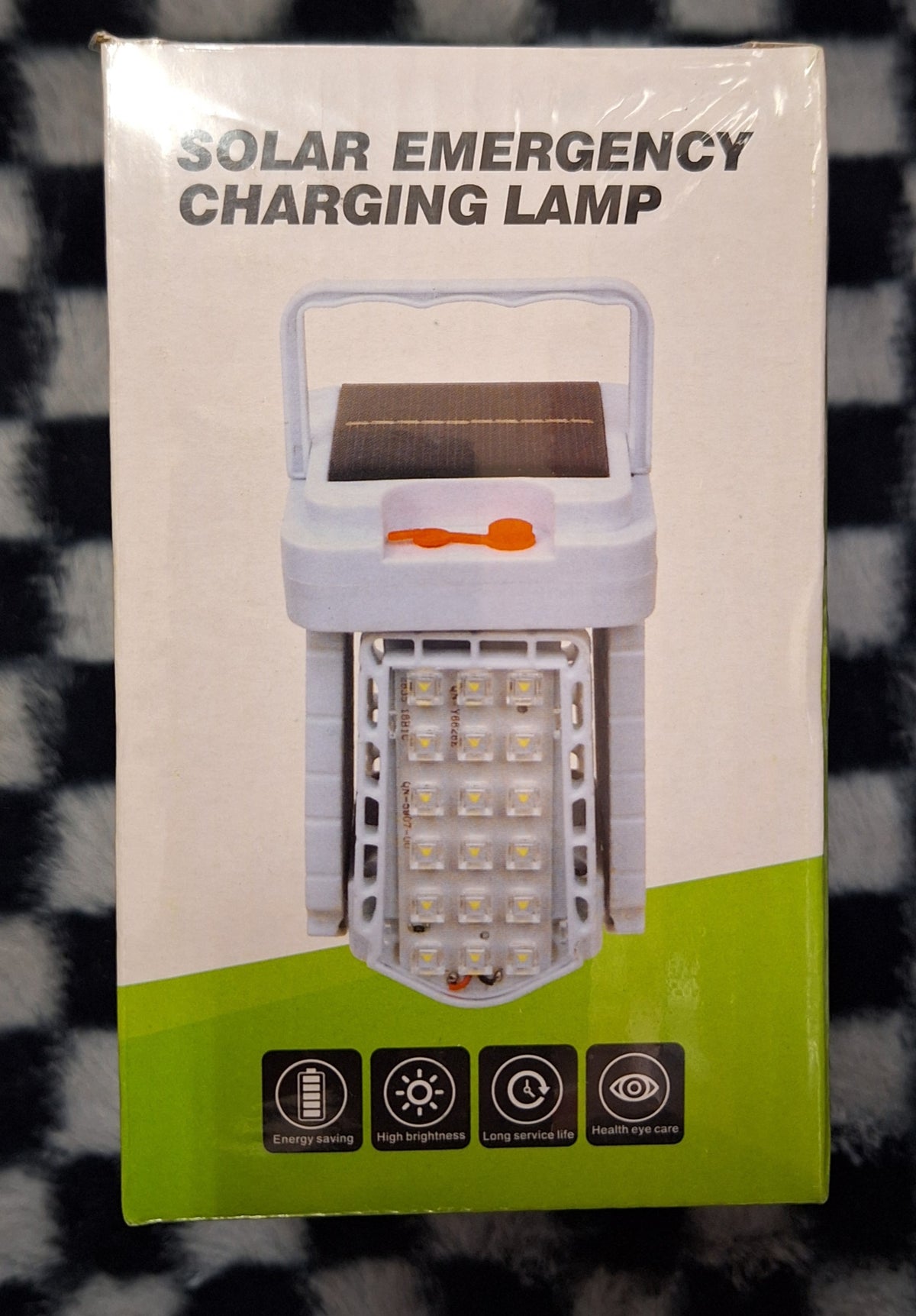 ET solar emergency charging lamp with built-in LED light and solar panel, portable device for outdoor and emergency use.
