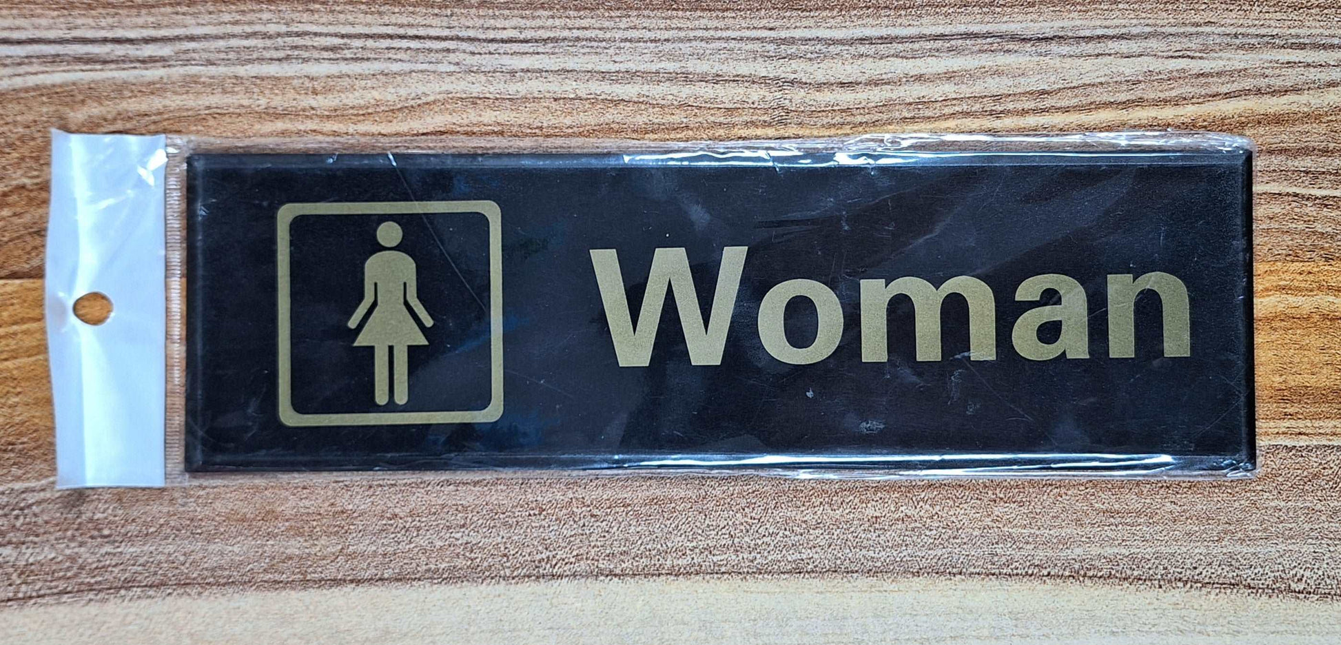 Black and Gold Woman Sign